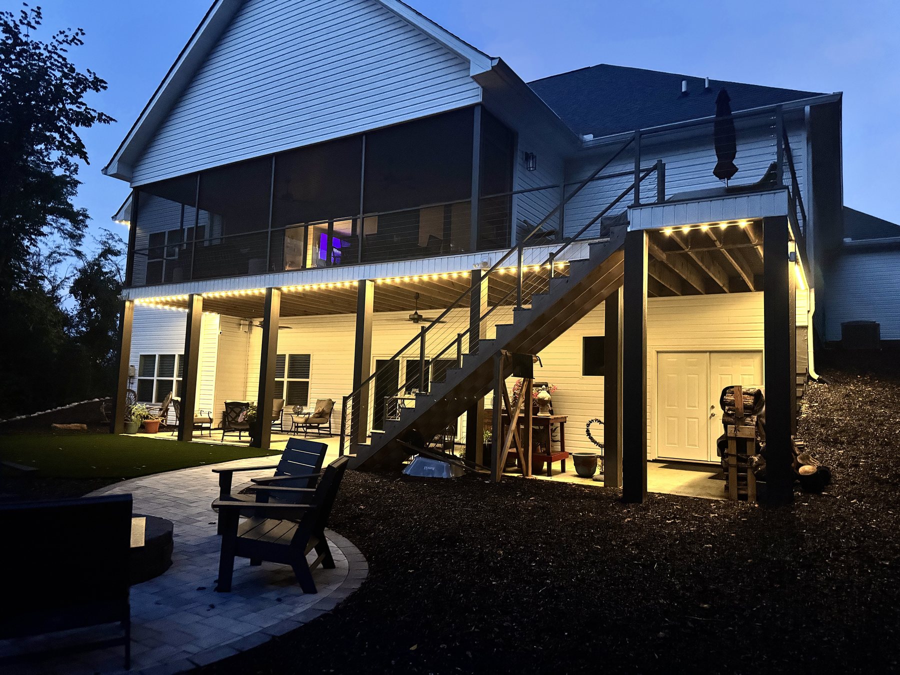 EverLume permanent architectural lighting along a covered patio at dusk